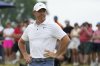 Rory McIlroy, of Northern Ireland, stands on the 11th green after putting in during the final round of the U.S. Open golf tournament at Oakmont Country Club Sunday, June 15, 2025, in Oakmont, Pa. (AP Photo/Gene J. Puskar)