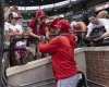 Los Angeles Angels manager Ron Washington, foreground, gives autographs to fans before a baseball game against the Baltimore Orioles, Friday, June 13, 2025, in Baltimore. (AP Photo/Alyssa Howell)