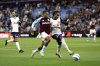 Aston Villa's Leon Bailey, left, and Tottenham Hotspur's Djed Spence battle for the ball during their English Premier League soccer match at Villa Park, Birmingham, England, Friday, May 16, 2025. (Nick Potts/PA via AP)
