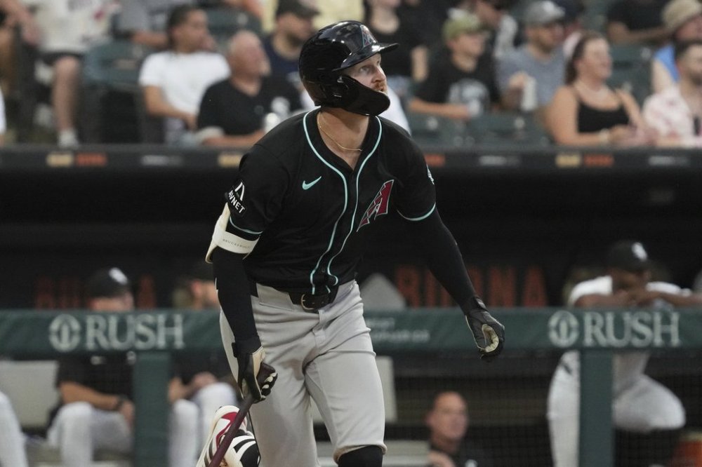 Arizona Diamondbacks' Pavin Smith watches his solo home run during the fourth inning of a baseball game against the Chicago White Sox in Chicago, Monday, June 23, 2025. (AP Photo/Nam Y. Huh)