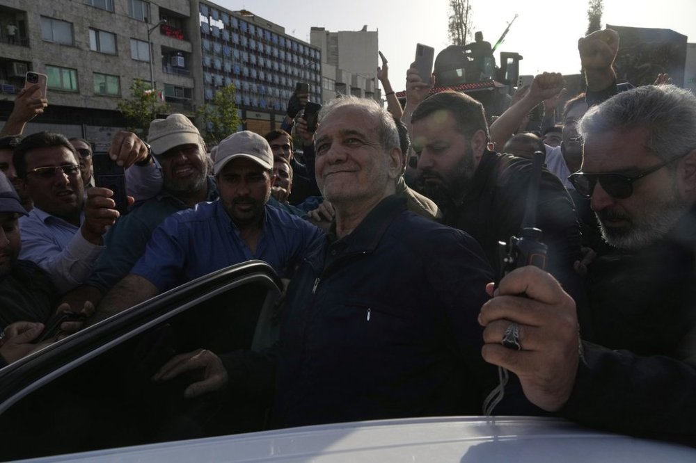 Iranian President Masoud Pezeshkian, centre, gets into his car after attending a protest following the U.S. attacks on nuclear sites in Iran, in Tehran, Iran, Sunday, June 22, 2025. THE CANADIAN PRESS/AP-Vahid Salemi