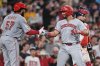 Cincinnati Reds' Christian Encarnacion-Strand, right, is congratulated by Rece Hinds (57) after his grand slam drive against the Boston Red Sox during the seventh inning of a baseball game at Fenway Park, Wednesday, July 2, 2025, in Boston. (AP Photo/Charles Krupa)