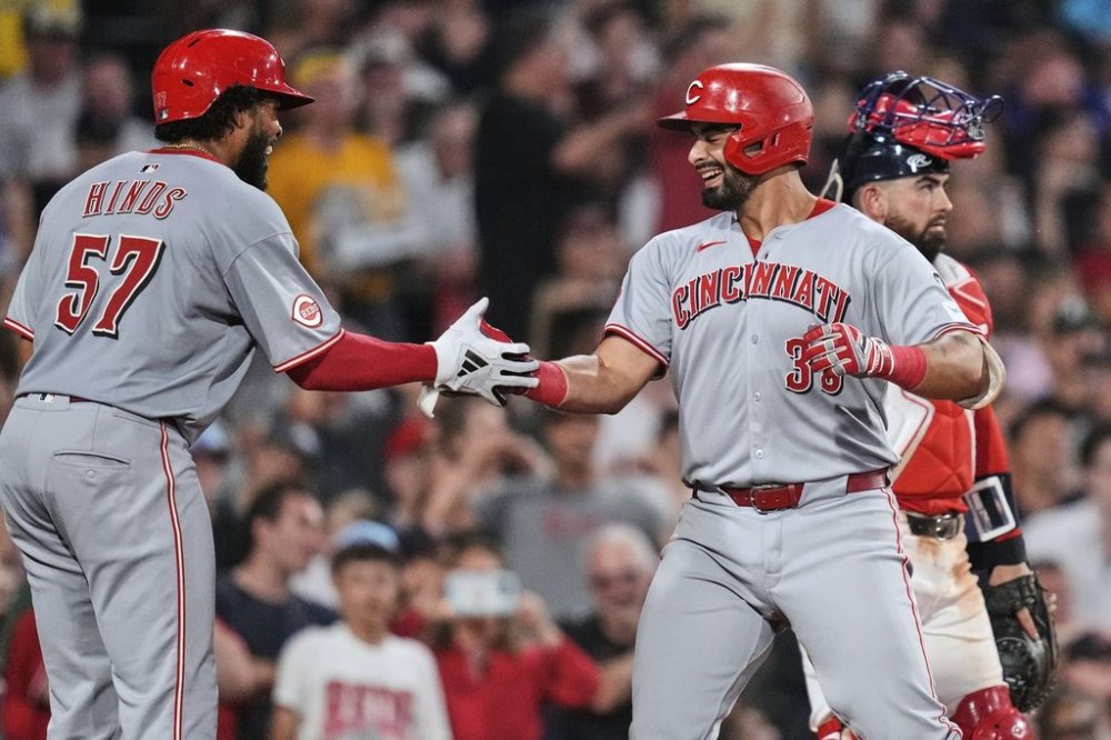 Cincinnati Reds' Christian Encarnacion-Strand, right, is congratulated by Rece Hinds (57) after his grand slam drive against the Boston Red Sox during the seventh inning of a baseball game at Fenway Park, Wednesday, July 2, 2025, in Boston. (AP Photo/Charles Krupa)