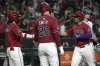 Arizona Diamondbacks' Gabriel Moreno celebrates with Alek Thomas (5) and Pavin Smith (26) after hitting a three run home run against the Seattle Mariners in the sixth inning during a baseball game, Tuesday, June 10, 2025, in Phoenix. (AP Photo/Rick Scuteri)