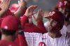 FILE - Philadelphia Phillies' Whit Merrifield celebrates with teammates after scoring during the fourth inning of a spring training baseball game against the Atlanta Braves, Feb. 28, 2024, in Clearwater, Fla. (AP Photo/Charlie Neibergall, File)