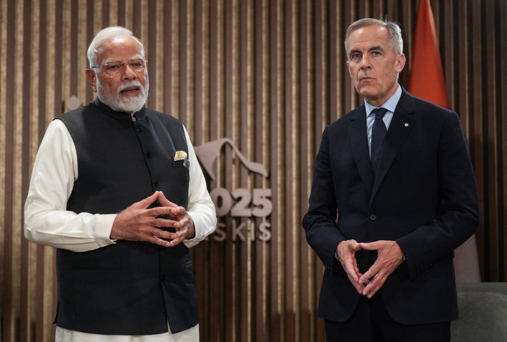 Indian Prime Minister Narendra Modi, left, speaks as Canadian Prime Minister Mark Carney listens before a meeting at the G7 Summit in Kananaskis, Alta., on Tuesday, June 17, 2025. THE CANADIAN PRESS/Darryl Dyck