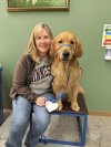 In this photo from 2022, provided by Helping Paws of Eden Prairie, Minn., state Rep. Melissa Hortman, DFL-Brooklyn Park, poses with Gilbert, a golden retriever trained to be a service dog but eventually adopted by the Hortman family, at a training facility in Hopkins, Minnesota. (Helping Paws via AP)