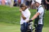Tommy Fleetwood, from England, reacts as Keegan Bradley prepares to putt for the win during the final round of the Travelers Championship golf tournament at TPC River Highlands, Sunday, June 22, 2025, in Cromwell, Conn. At right is Fleetwood's caddie Ian Finnis. (AP Photo/Jessica Hill)