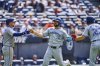 Toronto Blue Jays' Jonatan Clase, centre, is greeted by Myles Straw, left, and Ernie Clement (22) after scoring in the ninth inning of a baseball game against the Cleveland Guardians in Cleveland, Thursday, June 26, 2025. (AP Photo/Sue Ogrocki)