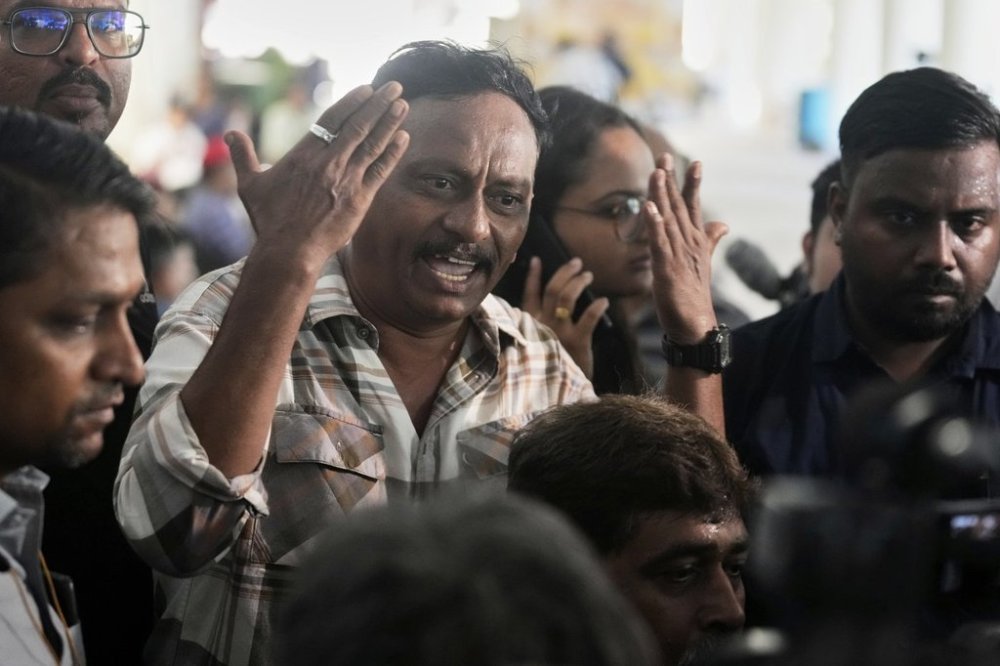 Ayub sheikh gestures angrily as he waits for the bodies of four relatives who died in the Air India plane crash, at a hospital in Ahmedabad, India, Saturday, June 14, 2025. (AP Photo/Rafiq Maqbool)