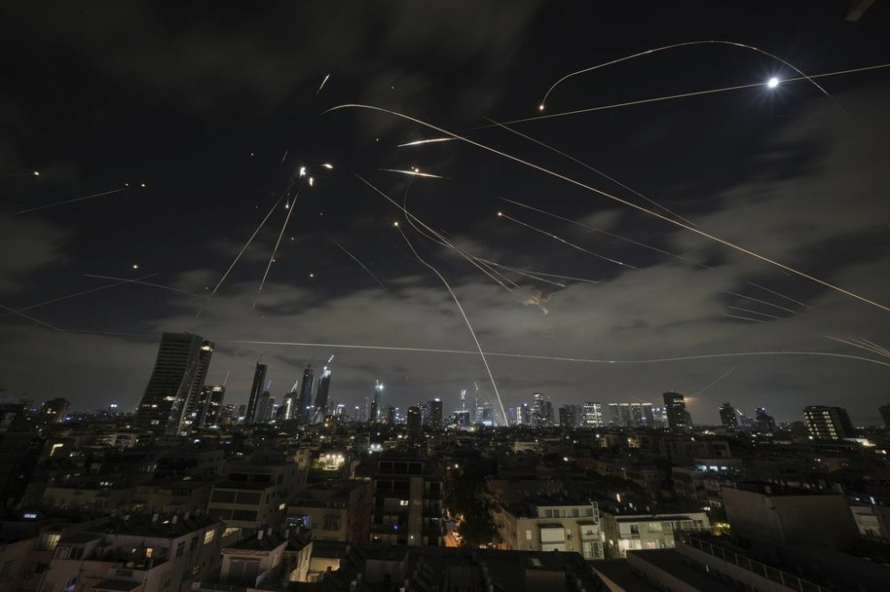 The Israeli Iron Dome air defense system fires to intercept missiles during an Iranian attack over Tel Aviv, Israel, Sunday, June 15, 2025. (AP Photo/Leo Correa)