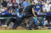 Philadelphia Phillies Nick Castellanos, left, and J.T. Realmuto, right, score on an RBI single by Bryson Stott in the seventh inning of a baseball game against the New York Mets, Friday, June 20, 2025, in Philadelphia. (AP Photo/Laurence Kesterson)