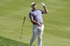 Scottie Scheffler drops his club after hitting his second shot from the rough on the first hole during the second round of the Travelers Championship golf tournament at TPC River Highlands, Friday, June 20, 2025, in Cromwell, Conn. (AP Photo/Jessica Hill)
