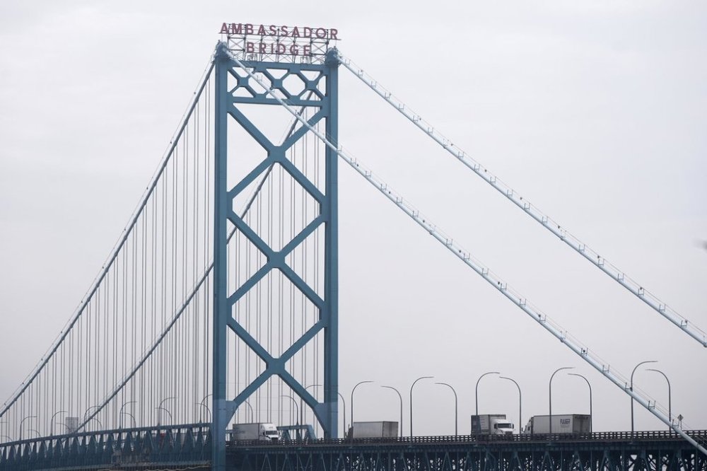 Trucks cross between the United States and Ontario, Canada across the Ambassador Bridge, Monday, Feb. 3, 2025, in Detroit. (AP Photo/Paul Sancya)