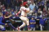 Philadelphia Phillies' Brandon Marsh, right, watches after hitting a game-winning RBI-single against Chicago Cubs pitcher Daniel Palencia during the 11th inning of a baseball game Monday, June 9, 2025, in Philadelphia. (AP Photo/Matt Slocum)