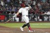 Arizona Diamondbacks' Josh Naylor watches the flight of his walk off grand slam to beat the Seattle Mariners during the 11th inning of a baseball game Monday, June 9, 2025, in Phoenix. (AP Photo/Ross D. Franklin)