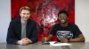 Bayer Leverkusen sporting director Simon Rolfes, left, sits with French defender Axel Tape after the club signed the player on a free transfer from Paris Saint-Germain, in Leverkusen, Germany, Wednesday, June 11, 2025. (D. Mesch/Bayer Leverkusen via AP)