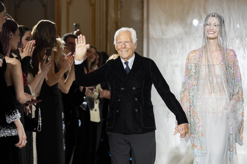 FILE - Giorgio Armani gestures at the end of the Giorgio Armani Prive Haute Couture Spring Summer 2025 collection in Paris, on Jan. 28, 2025. (AP Photo/Lewis Joly, File).