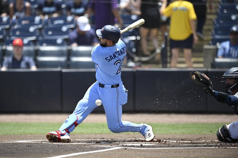 Toronto Blue Jays' Anthony Santander, left, fouls off a pitch as Tampa Bay Rays catcher Ben Rortvedt looks on during the first inning of a baseball game, Sunday, May 25, 2025, in Tampa, Fla. (AP Photo/Phelan M. Ebenhack)