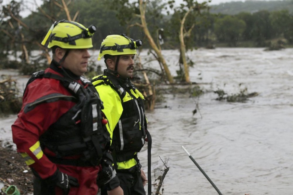 Kerrville Fire Department first responders scan the banks of the Guadalupe River for individuals swept away by flooding in Ingram, Texas, Thursday, July 4, 2025. (Michel Fortier/The San Antonio Express-News via AP)