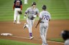 Colorado Rockies' Michael Toglia (4) rounds the bases on his home run next to third base coach Andy González (70) during the seventh inning of a baseball game against the Washington Nationals, Tuesday, June 17, 2025, in Washington. (AP Photo/Nick Wass)