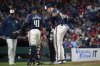 Cleveland Guardians relief pitcher Andrew Walters, right, holds his arm after an injury as Carlos Santana (41) and manager Stephan Vogt, left, look on during the ninth inning of a baseball game against the Los Angeles Angels, Friday, May 30, 2025, in Cleveland. (AP Photo/Phil Long)