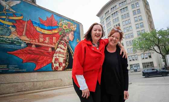 Take Pride Winnipeg unveiled a new mural at 492 Main Street Monday. “Pray for Ukraine,” was the vision of Ukrainian activist Liudmyla Shykota (left); it was brought to life by artist Jennifer Mosienko, who has painted more than 40 murals in the city. (Ruth Bonneville / Free Press)