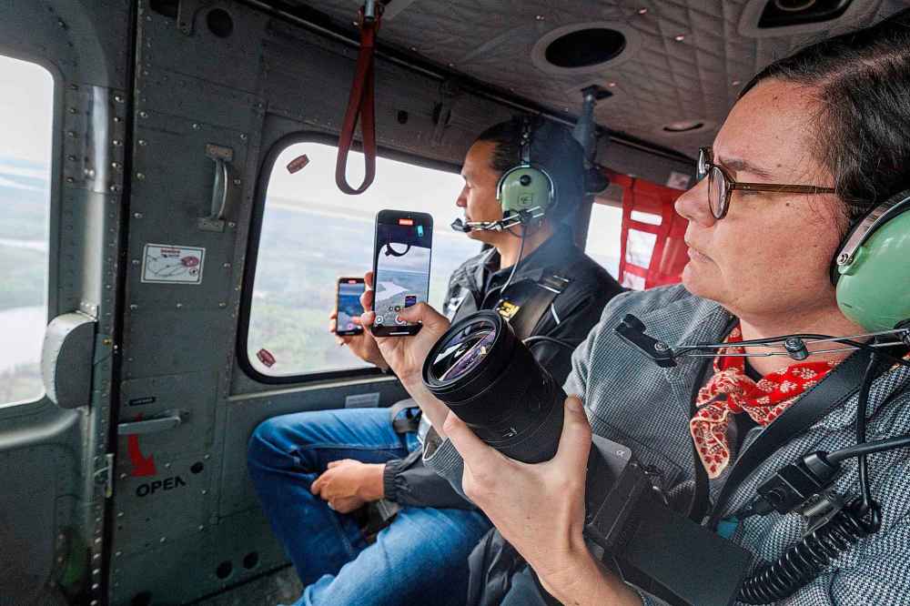 Premier Wab Kinew in the helicopter touring the area around Flin Flon.