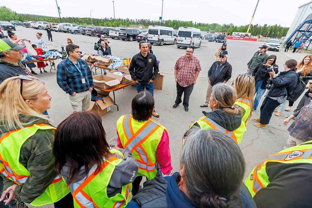 Premier Wab Kinew meets with staff from the MMF outside the evacuation centre at the Thompson Regional Community Centre in Thompson.