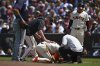 San Francisco Giants manager Bob Melvin (6) checks on Matt Chapman (26) after injuring himself on a play in the eighth inning of a baseball game against the Atlanta Braves at Oracle Park in San Francisco, Sunday, June 8, 2025. (Jose Carlos Fajardo/Bay Area News Group via AP)
