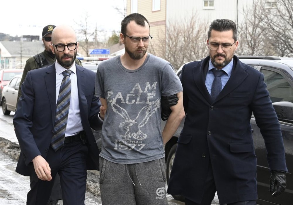 Steeve Gagnon is escorted by police into court in Amqui, Que., Tuesday, March 14, 2023. THE CANADIAN PRESS/Jacques Boissinot