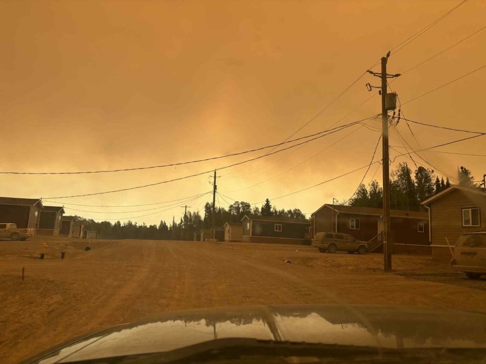 Smoke from wildfires is shown at Sandy Lake First Nation, Ont., in this Saturday, June 7, 2025, handout photo. THE CANADIAN PRESS/Handout - Destiny Rae (Mandatory Credit)