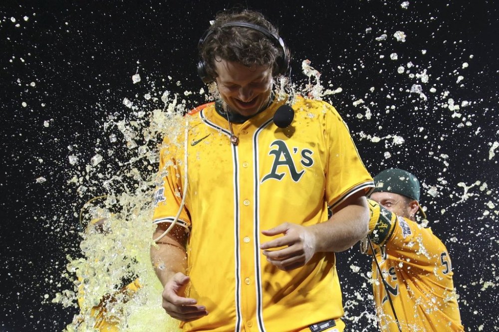 Athletics' Nick Kurtz is splashed by gatorade after he hits a walk off two run home run against the Houston Astros during the 10th inning of a baseball game Thursday, June 19, 2025, in West Sacramento, Calif. (AP Photo/Scott Marshall)
