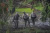 Officials inspect an area at Camp Mystic along the banks of the Guadalupe River after a flash flood swept through the area Sunday, July 6, 2025, in Hunt, Texas. (AP Photo/Julio Cortez)