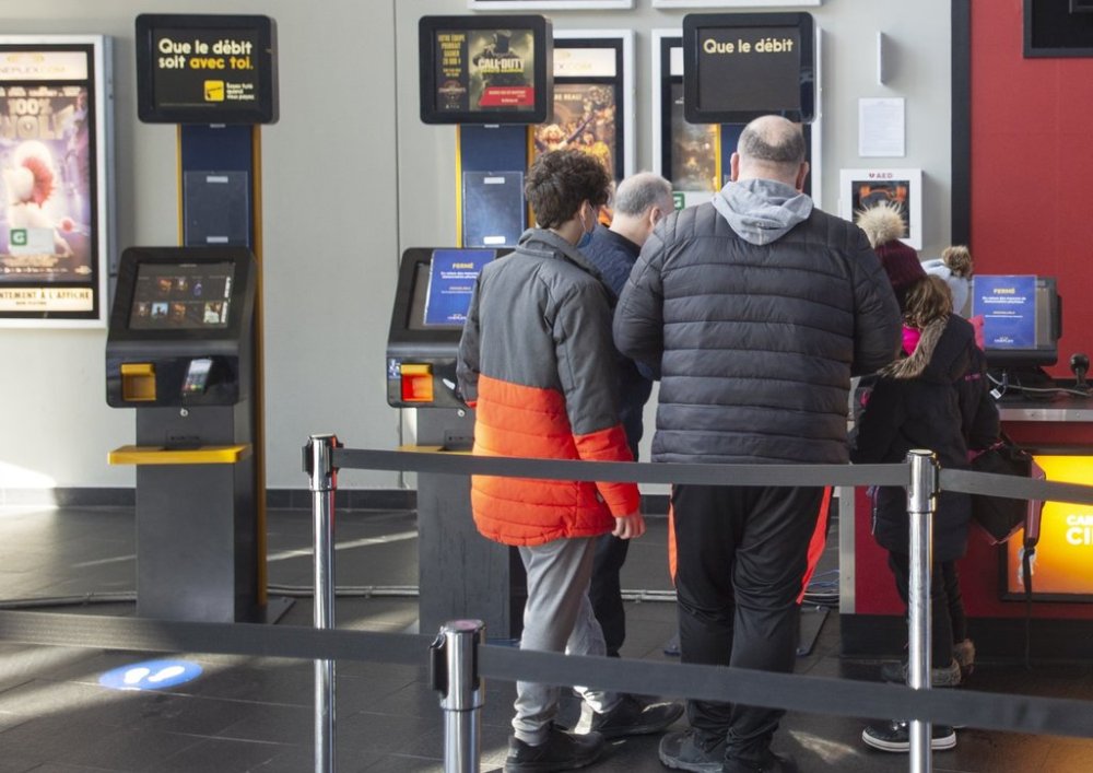 People buy tickets at a Cineplex movie theatre in Laval, Que., on Friday, Feb. 26, 2021. THE CANADIAN PRESS/Ryan Remiorz