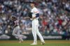 Seattle Mariners starting pitcher George Kirby, foreground, stands on the field as Cleveland Guardians' José Ramírez, back left, rounds the bases on a solo home run during the fifth inning of a baseball game, Saturday, June 14, 2025, in Seattle. (AP Photo/John Froschauer)