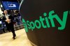 A trading post sports the Spotify logo on the floor of the New York Stock Exchange on Tuesday, April 3, 2018. (AP Photo/Richard Drew, File)