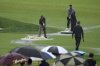 Grounds keepers clear water from the course during a weather delay in the final round of the U.S. Open golf tournament at Oakmont Country Club Sunday, June 15, 2025, in Oakmont, Pa. (AP Photo/Gene J. Puskar)