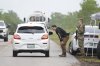 Police check cars arriving at the 