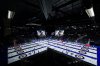 Reflected in a window of an arena suite, Alberta-Sluchinski second Kerr Drummond, bottom right, delivers a rock while playing Quebec during the Brier, in Regina, on Wednesday, March 6, 2024. THE CANADIAN PRESS/Darryl Dyck