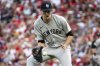 New York Yankees pitcher Max Fried catches a bouncing ball and throws to first base for an out in the third inning of a baseball game against the Cincinnati Reds, Wednesday, June 25, 2025, in Cincinnati. (AP Photo/Michael Swensen)