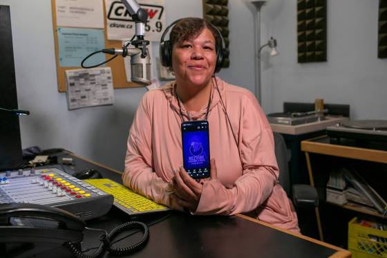 Rez Vibe Connections host Stephanie Kersey, 43, shows an image of her show’s logo on her cellphone inside the CKUW DJ booth at the University of Winnipeg. (Brook Jones / Free Press)