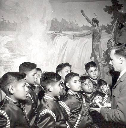 Gar Lunney / Archives and Special Collections, Western Libraries, Western University
In this April 1951 photo, the Black Hawks are shown at the Chateau Laurier in front of a mural by C.W. Jefferys called Indians Paying Homage to the Spirit of Chaudiere.