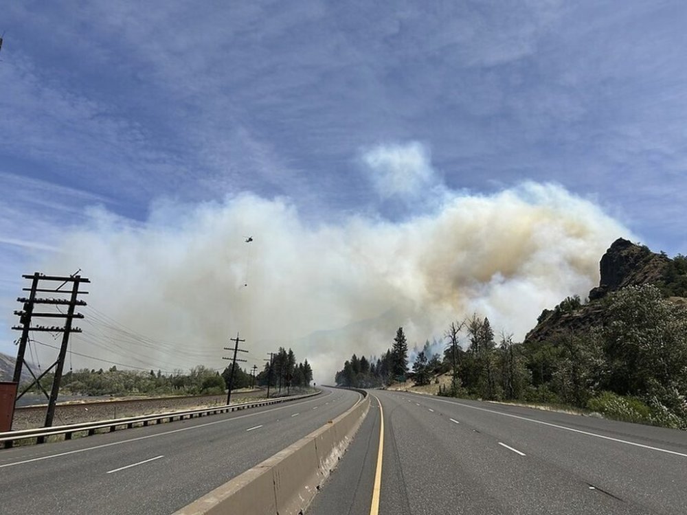 A photo provided by the Oregon Department of Transportation shows smoke from a wildfire that shut down Interstate 84 between Hood River and The Dalles in Ore., Wednesday, June 11, 2025. (Oregon Department of Transportation via AP)