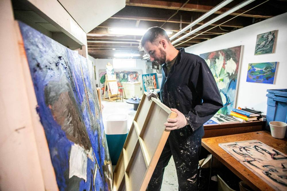 MIKAELA MACKENZIE / FREE PRESS
Painter Brian Hunter shows the wooden canvases he uses to paint on in his basement studio.