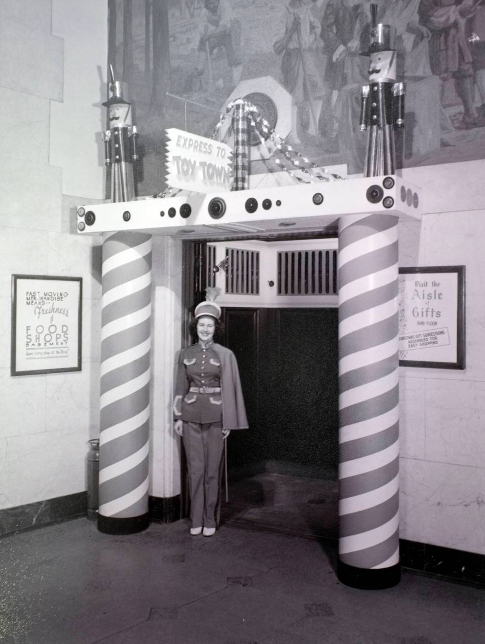 Hudson’s Bay Company Archives, Manitoba Archives
Doreen Hardie appears on the job in a photo taken in 1947 of her working as the elevator operator at the Bay dressed in a toy soldier costume.