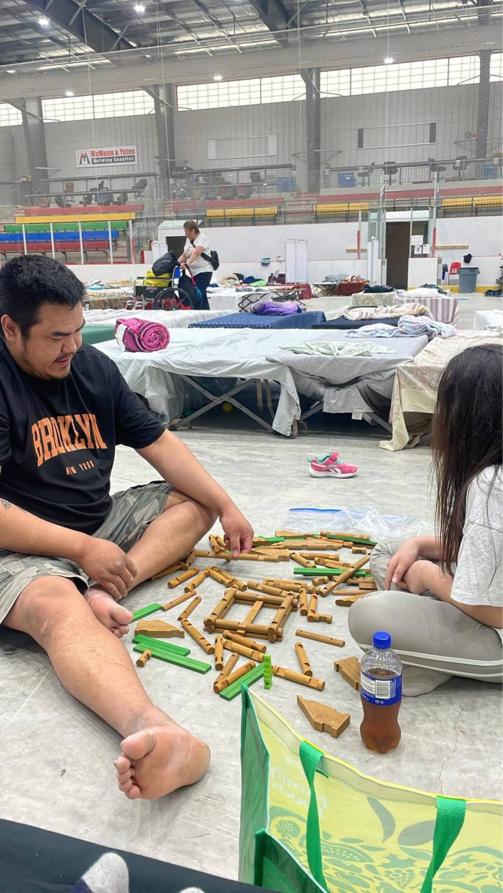 SUPPLIED
                                Lori Osborne's boyfriend, Stephan Robinson, left, and daughter Sophie Osborne, 10, pass the time while staying at the multiplex in Peguis First Nation.