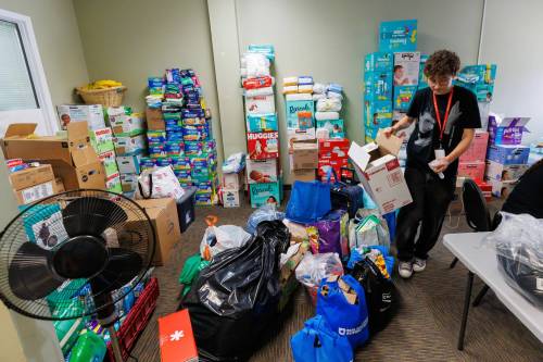 MIKE DEAL / FREE PRESS
                                Kit Carleton a staff member at the Louis Riel Institute volunteers at the MMF’s emergency centre.