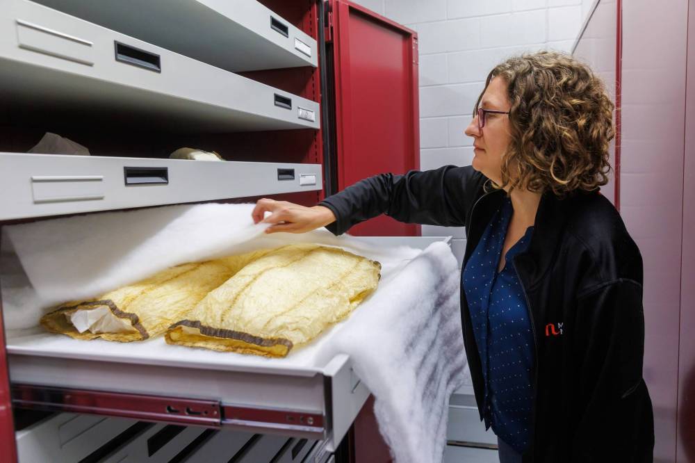 MIKE DEAL / FREE PRESS
Amelia Fay, curator of anthropology and the HBC Museum Collection at the Manitoba Museum, displays a pair of waterproof gutskin pants.
