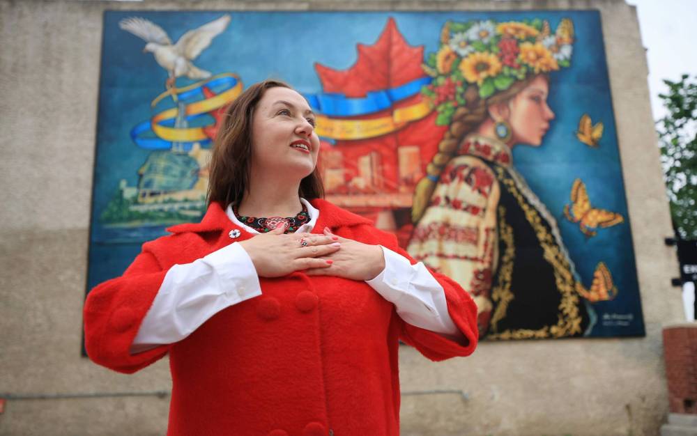 Ukrainian newcomer Mila Shykota spearheaded the creation of Take Pride Winnipeg‘s newest Exchange District mural, titled “Pray for Ukraine.” Shykota worked with local artist, Jennifer Mosienko, who has painted over forty murals in the city. (Ruth Bonneville / Free Press)